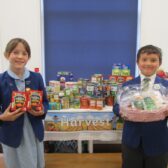 Photo of children in school uniform with food hub gifts
