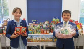 Photo of children in school uniform with food hub gifts