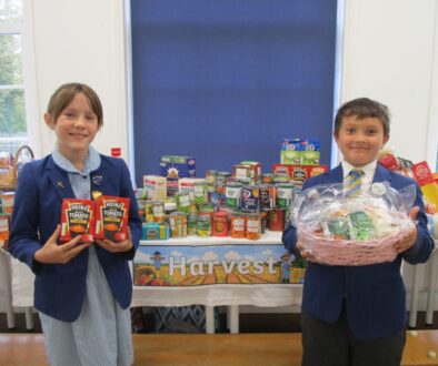 Photo of children in school uniform with food hub gifts