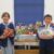 Photo of children in school uniform with food hub gifts