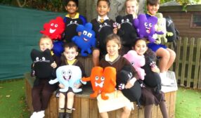 Photo of children holding Jigsaw puzzle pieces