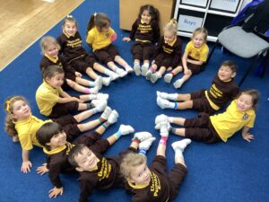 children sitting in a circle with feet touching